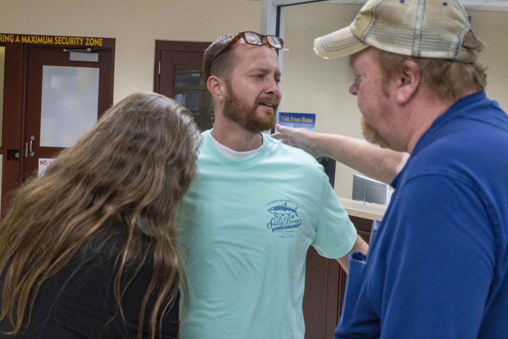 Joey Watkins, wrongfully convicted and exonerated after 22 years, shares a heartfelt moment with his family during his court exoneration in 2023.